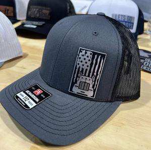 Charcoal Richardson 112 Trucker Hat with black and silver laser engraved Trucker Leatherette Patch and adjustable snapback