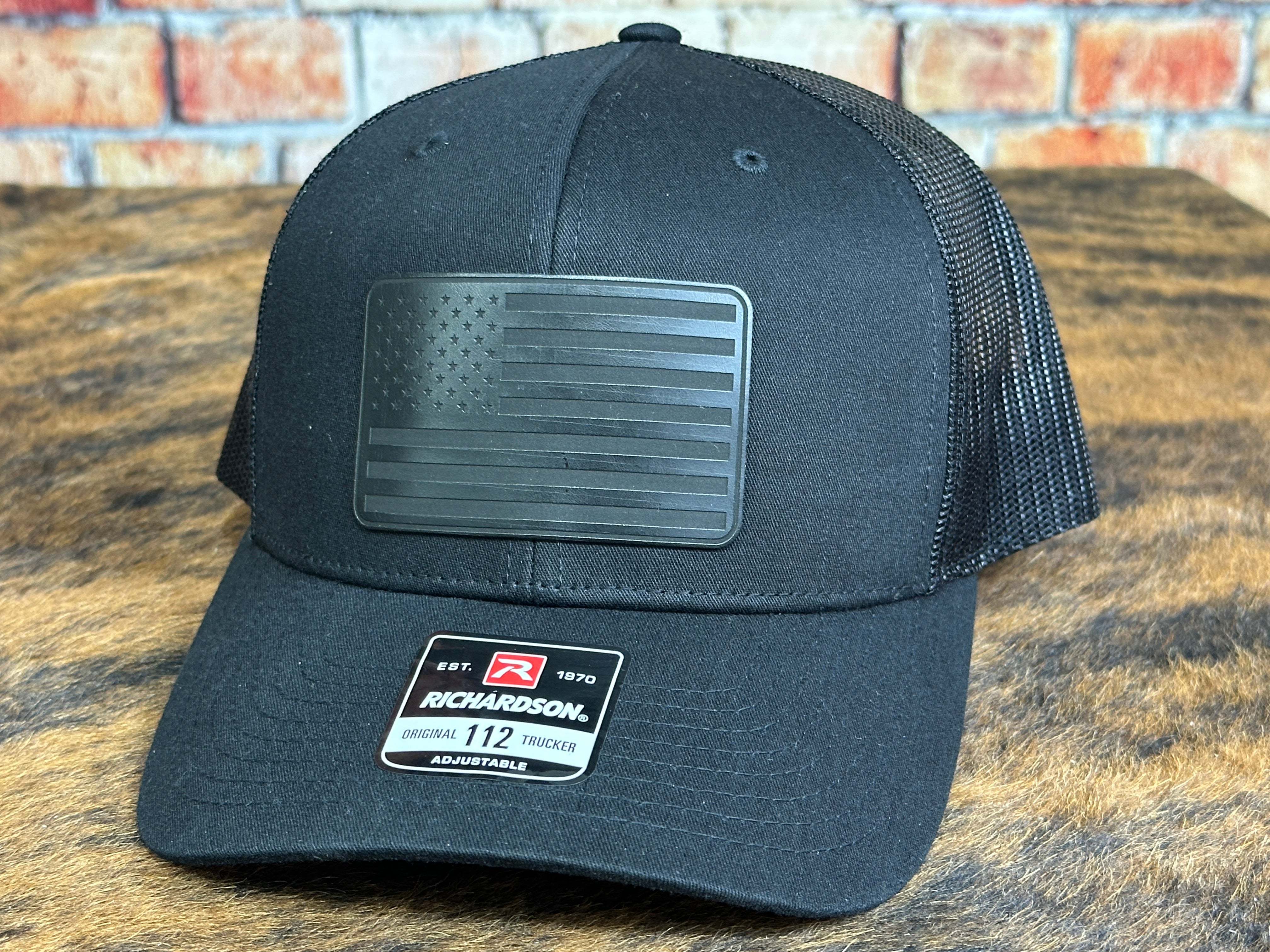 Blackout American Flag Richardson 112 trucker hat with leatherette patch and adjustable snapback