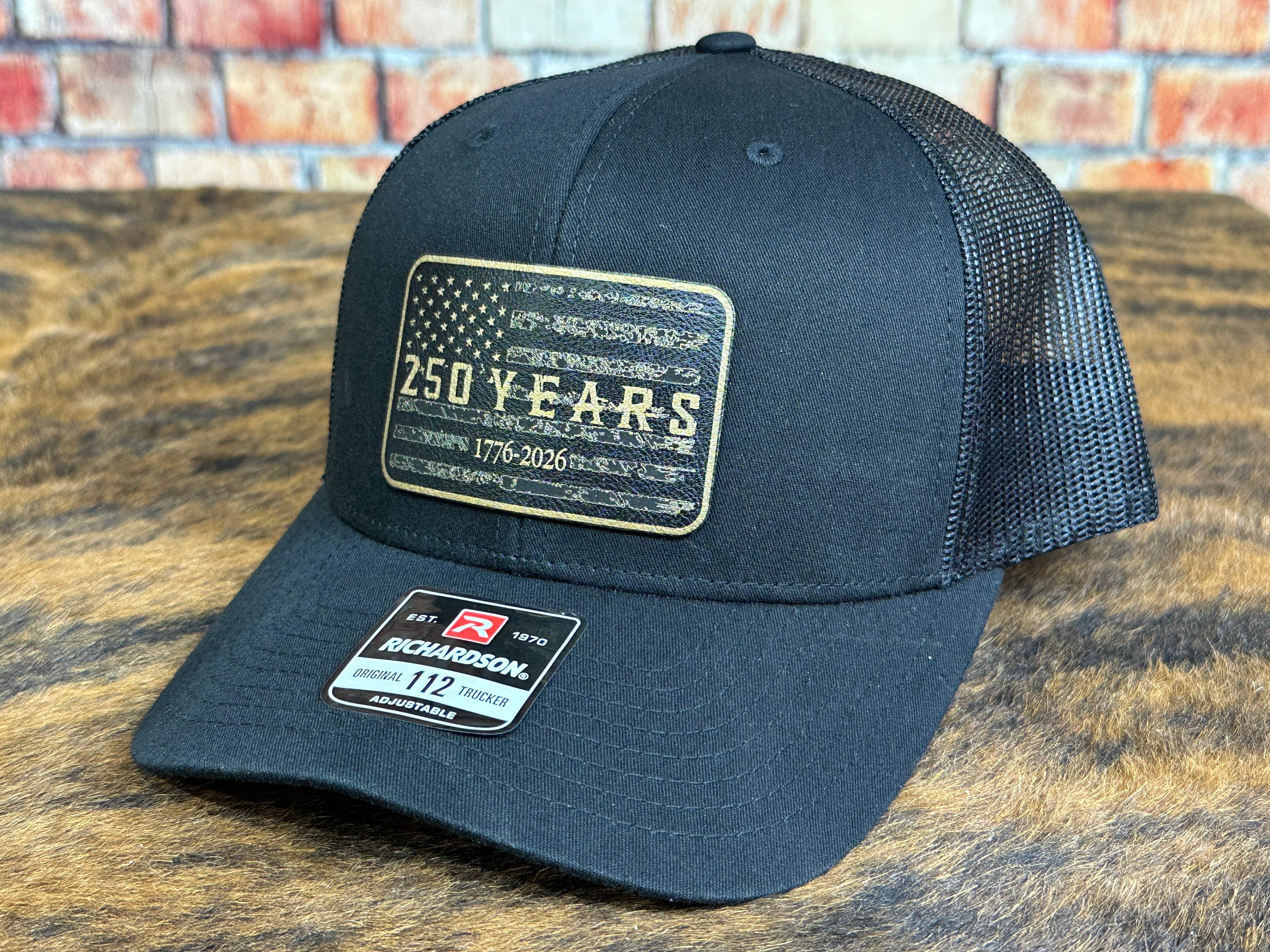 Blackout American Flag Richardson 112 trucker hat with distressed 250 years heritage patch