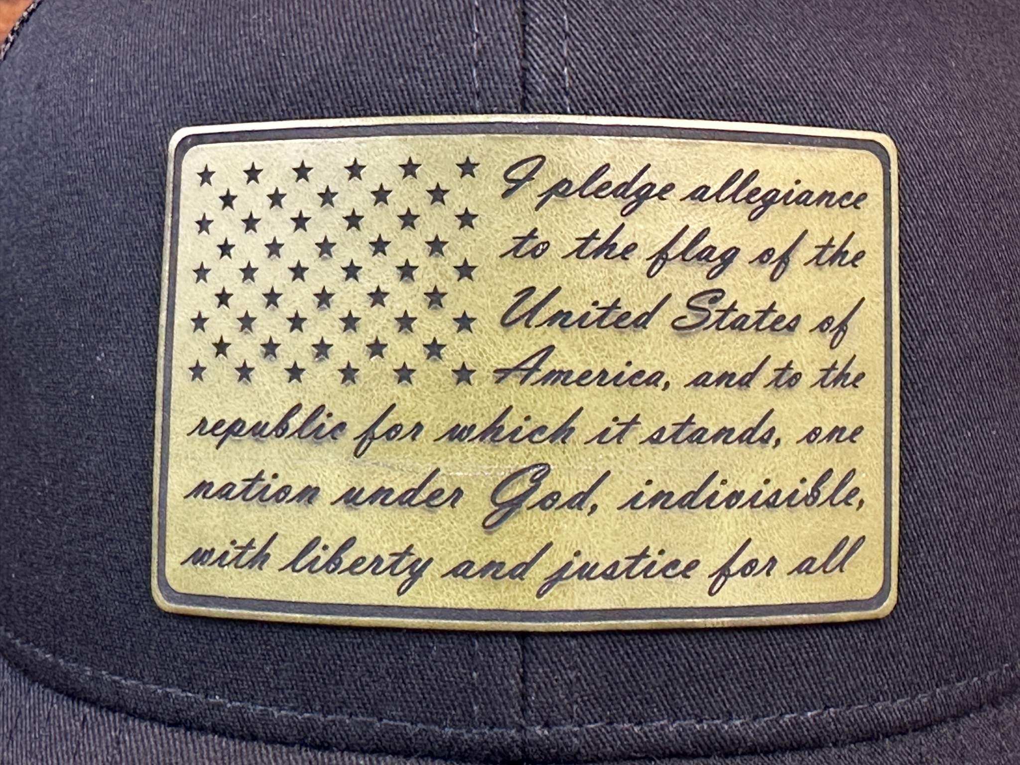 black cap with an American flag patch and pledge of allegiance text