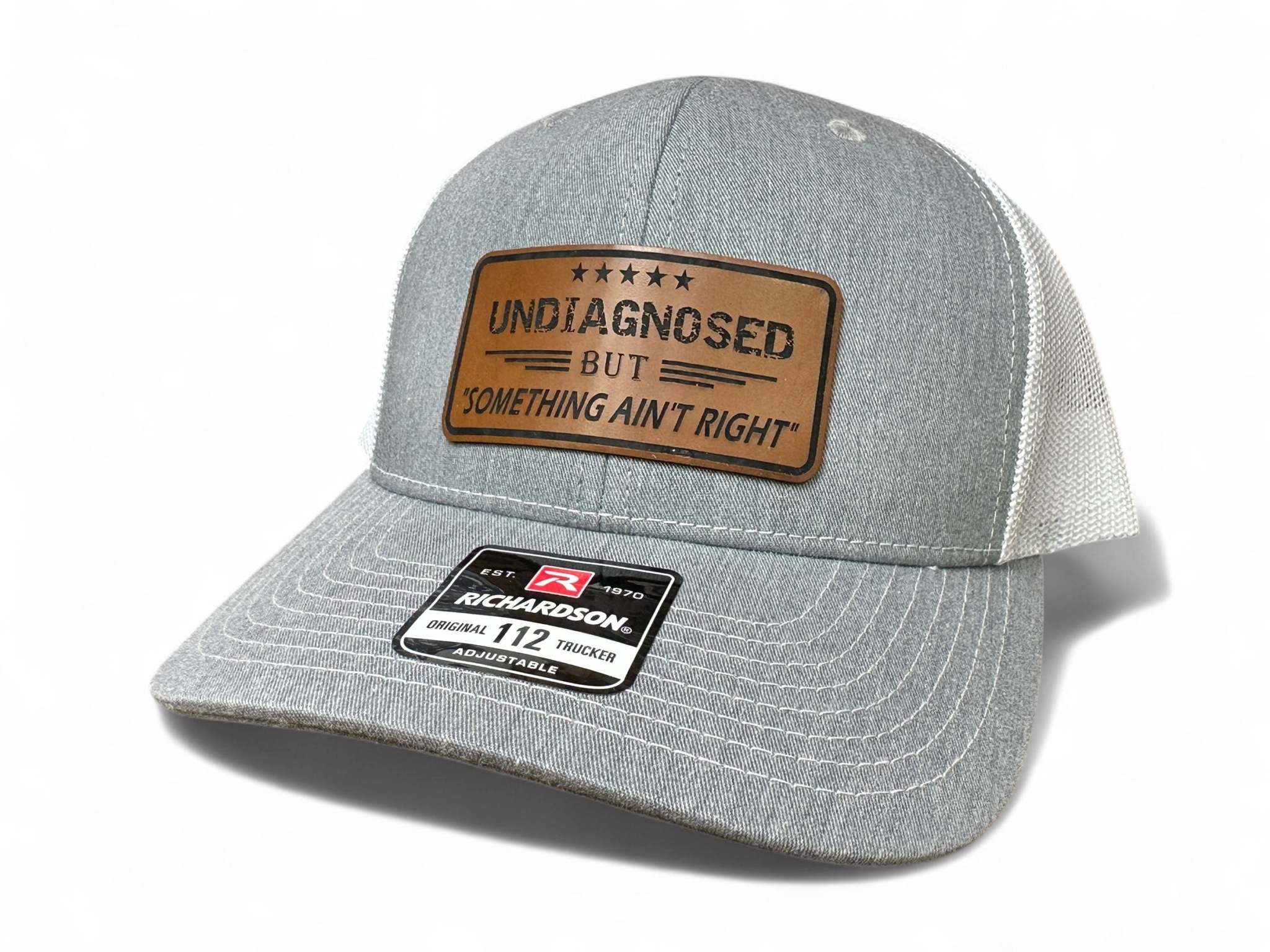 Richardson 112 trucker snapback hat with laser engraved leatherette patch reading Something Aint Right Hat
