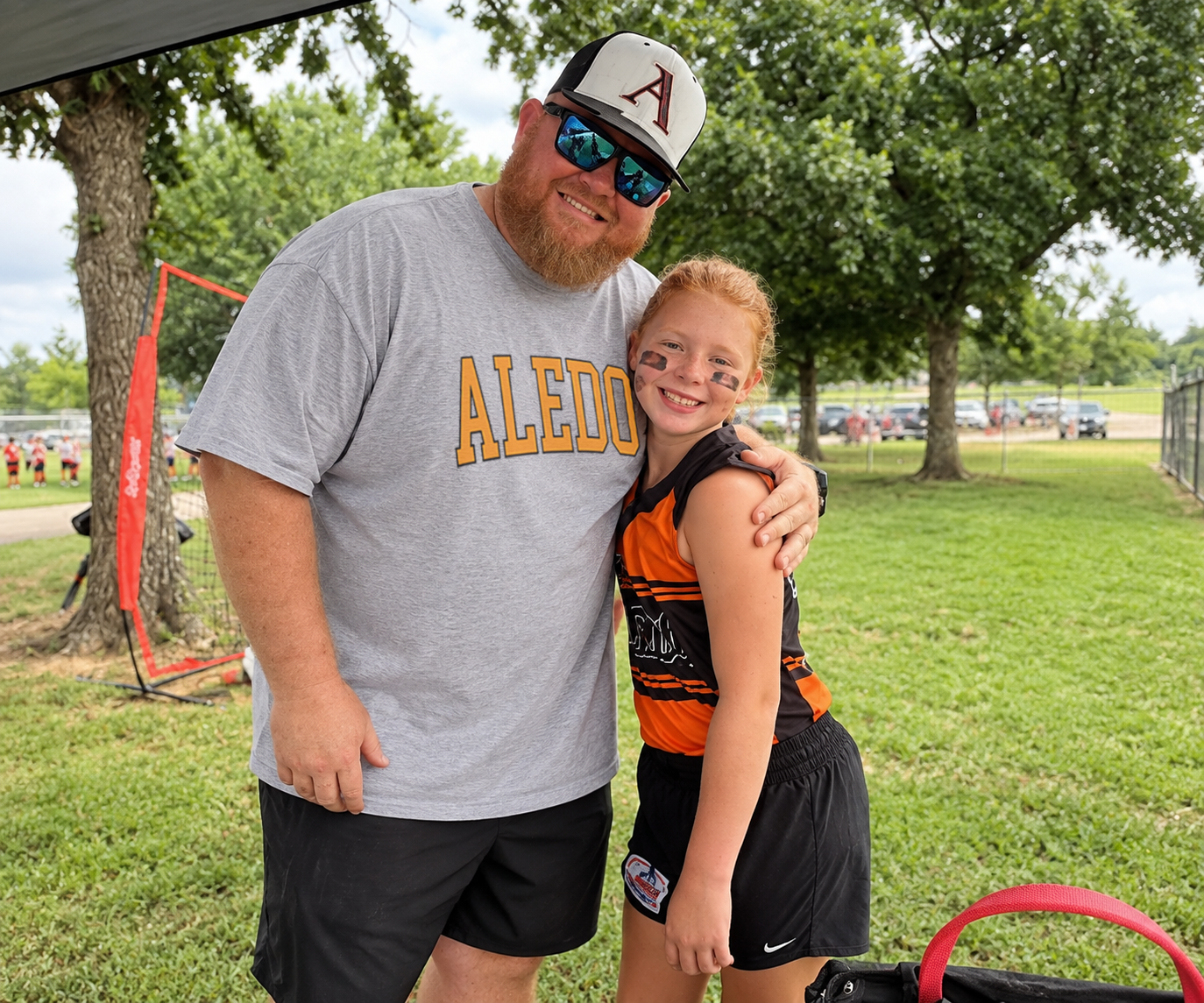 Sport grey vintage varsity Aledo team T-shirt worn at a softball game