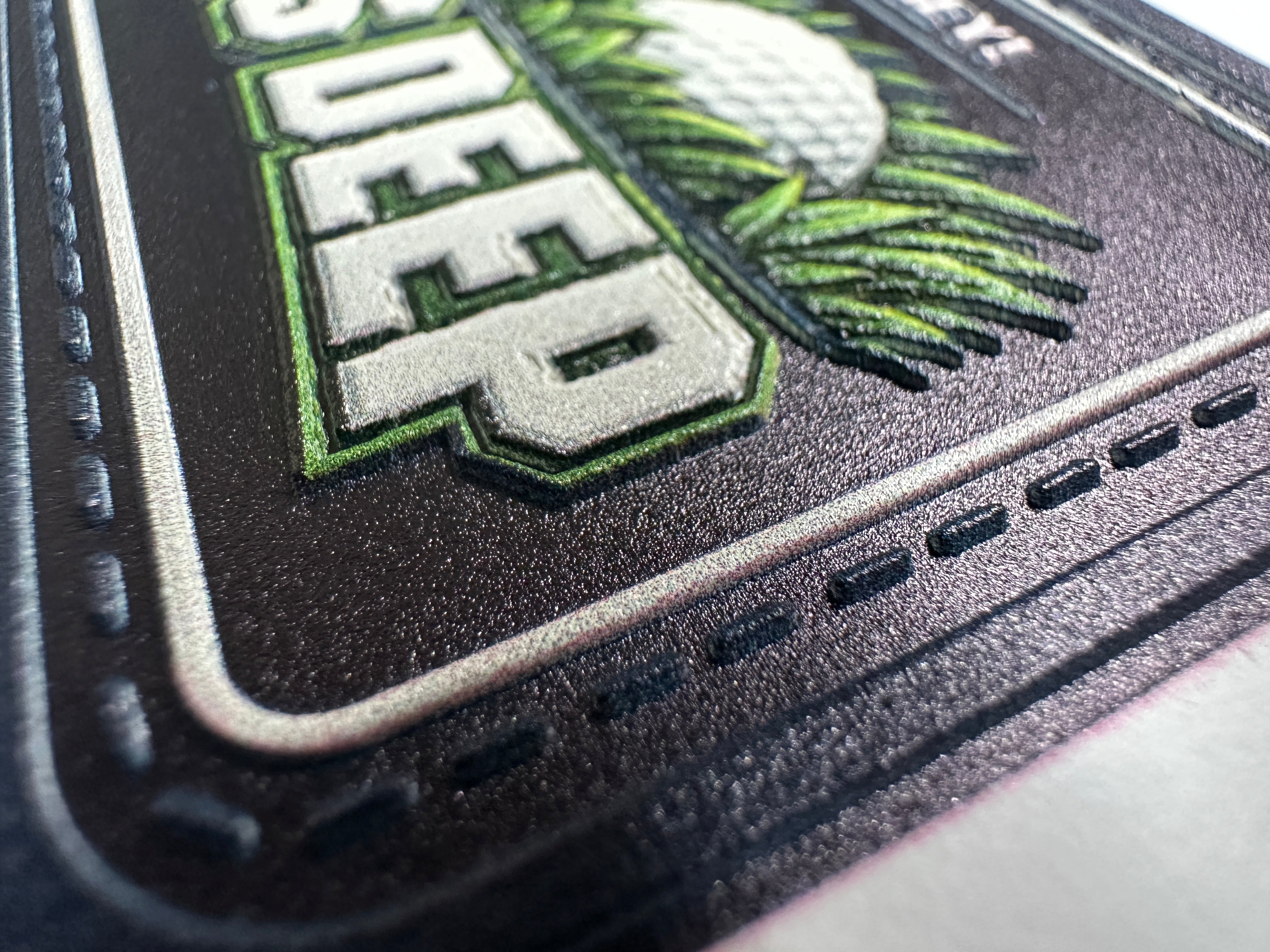 Close-up of a logo with green text and design on a black background