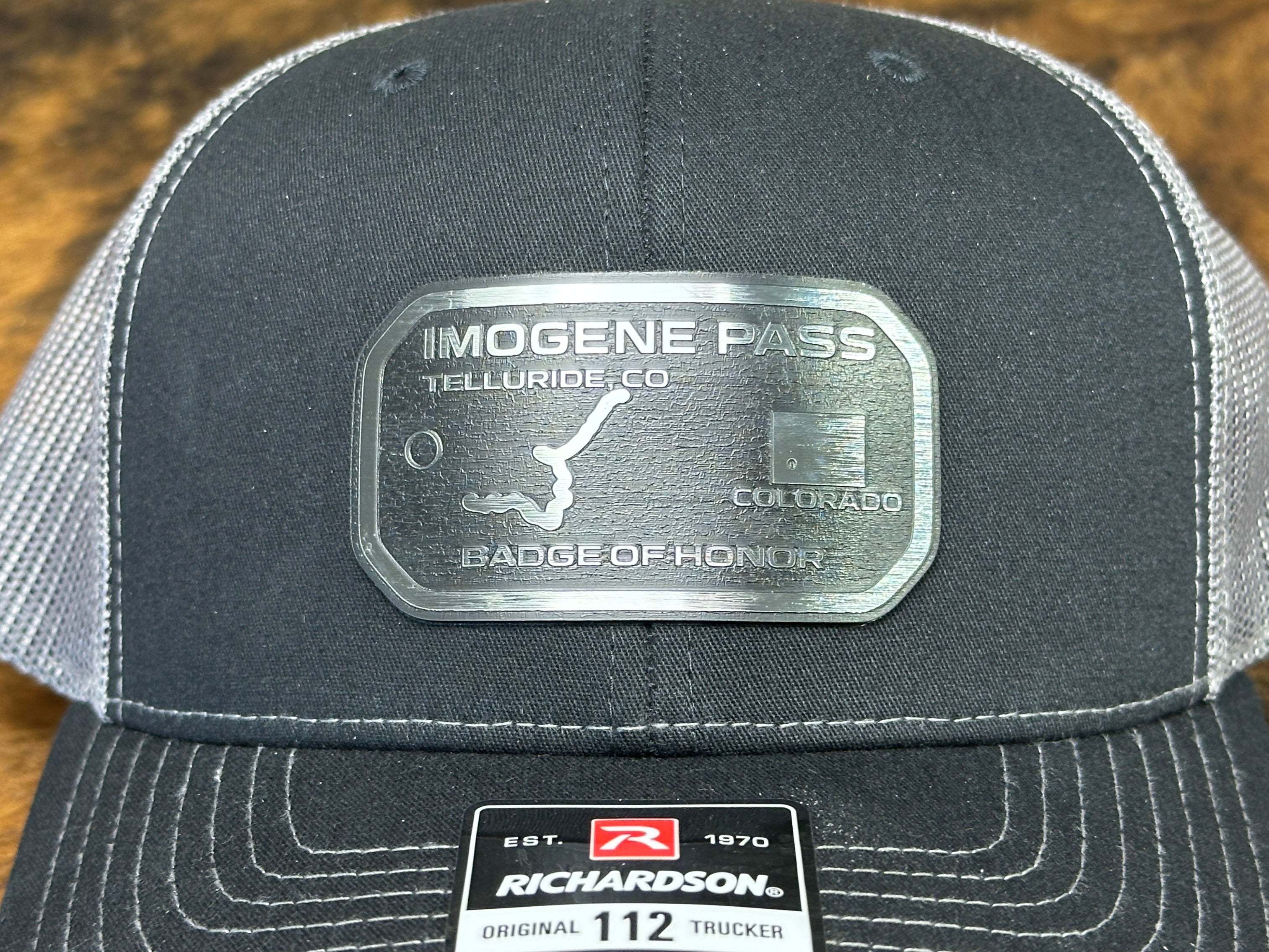 Close-up of a black cap with badge engraved into wholesale acrylic Patches